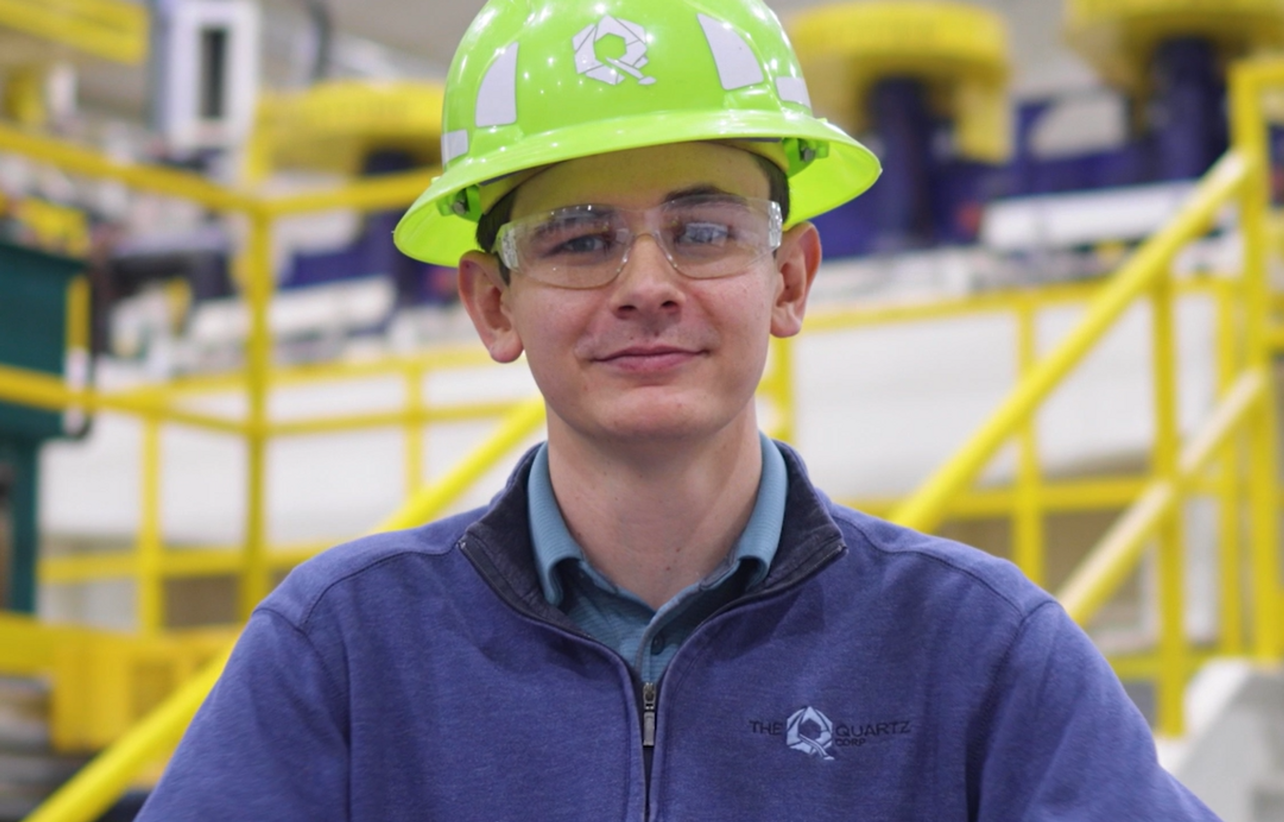 Headshot of a male employee with ppe representing industrial engineering jobs.  
